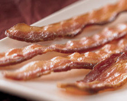 Thick strips of bacon on a plate... what's better than that divine smell in the morning?
