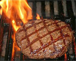 A juicy GSI Angus steak patty grilling on the barbecue... there's nothing quite like it! Order yours today!